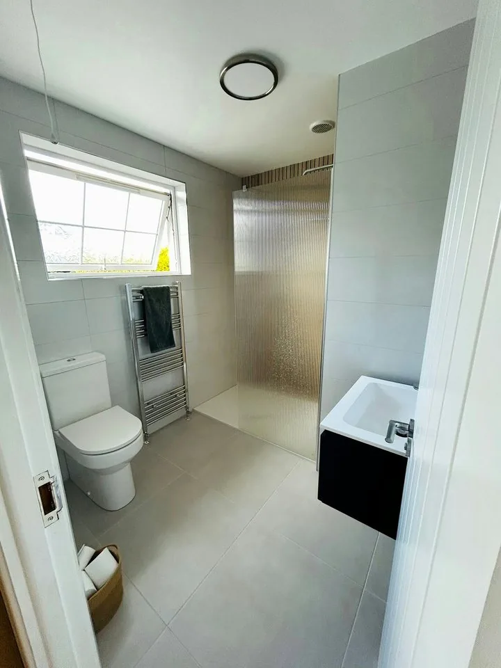 Shower room with walk-in shower, toilet and vanity unit