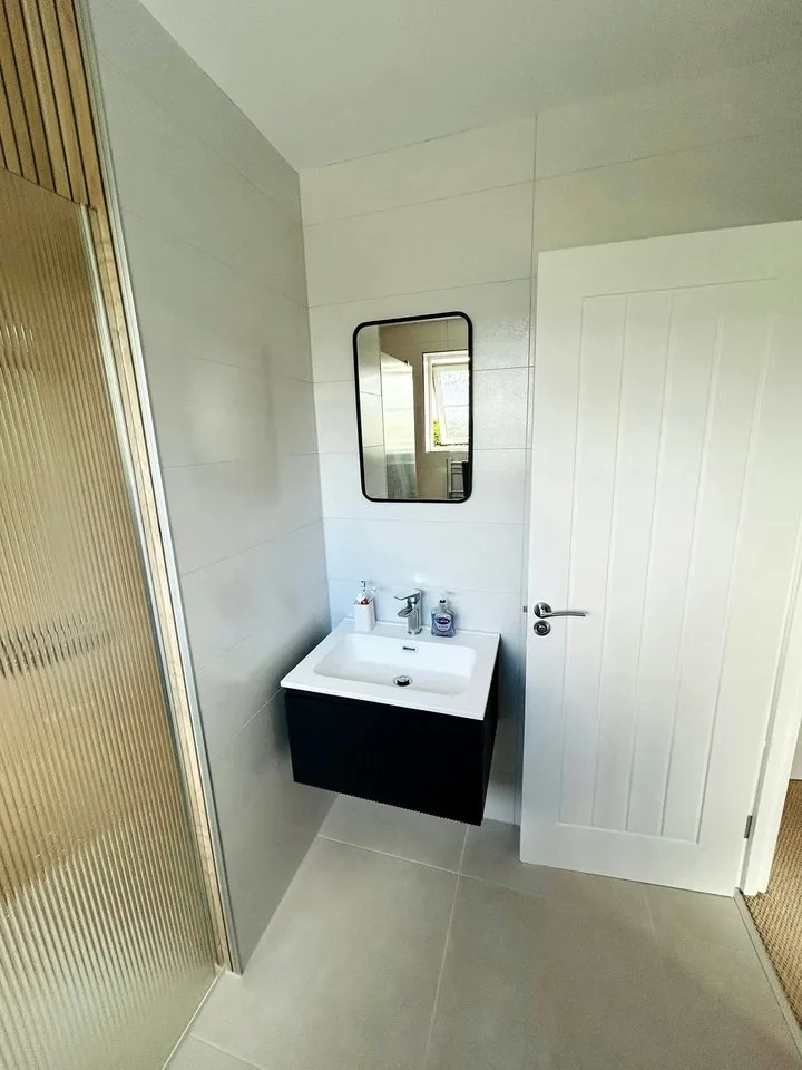 Vanity unit and mirror beside the walk-in shower