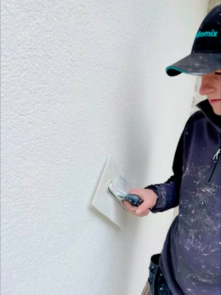 Finishing a rendered wall with a trowel