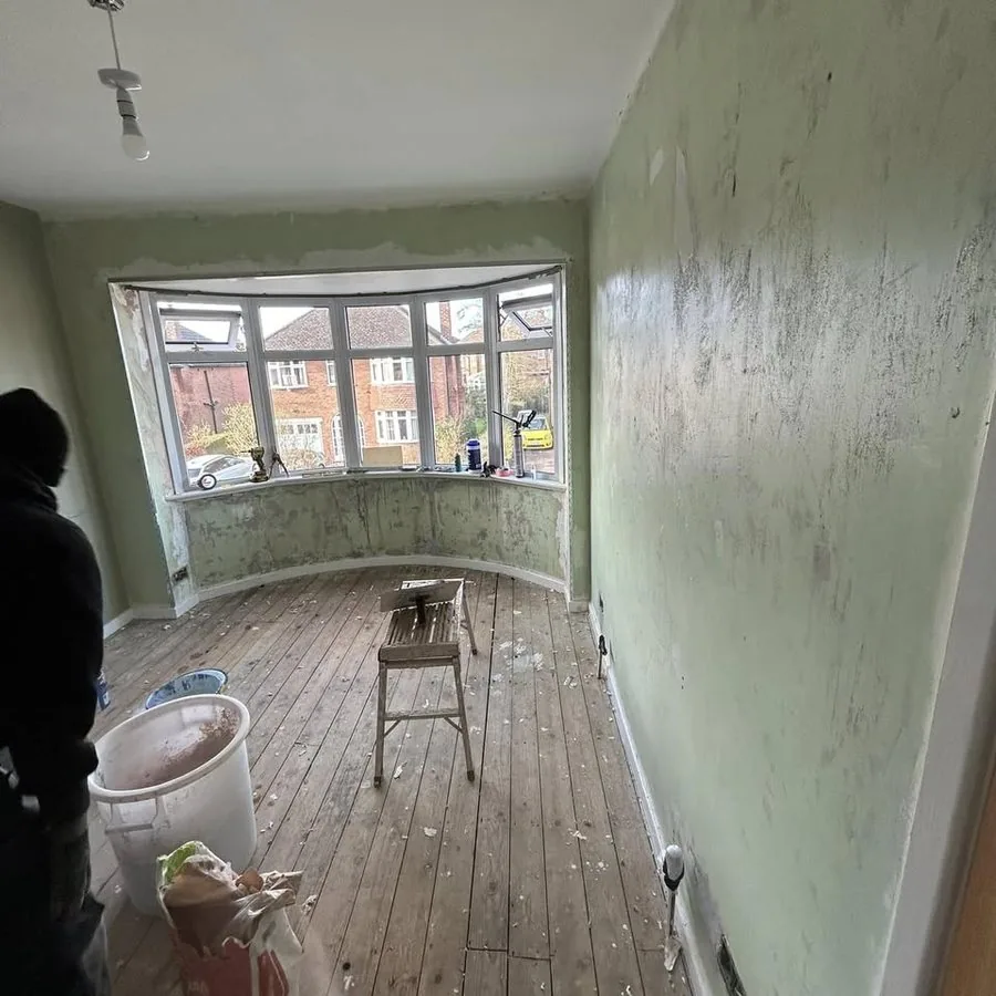 Before: a bay-window room with old wallpaper
