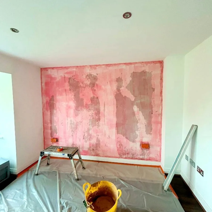 Before: a stripped wall ready for plastering