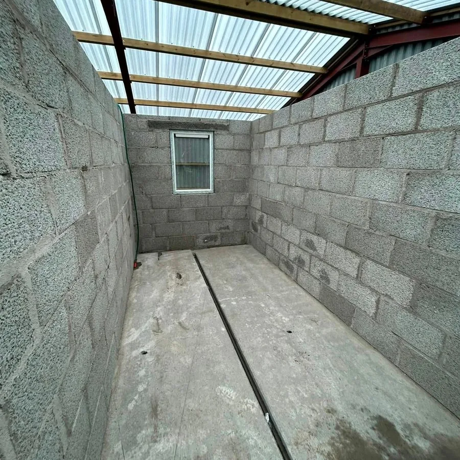 Before: a bare block outbuilding