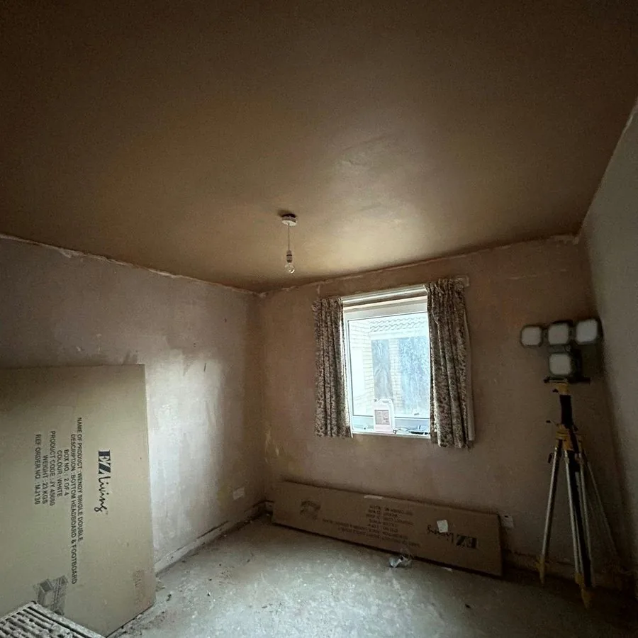 After: the same room with new plaster on walls and ceiling
